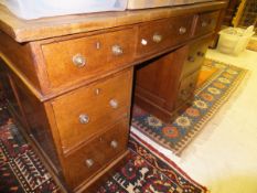 A Victorian oak partner's desk, the tooled and gilded leather insert top over three drawers,