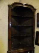 An 18th Century walnut hanging corner unit with three shaped open shelves