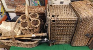 A collection of wicker baskets to include a wine carrier, etc, various suitcases,