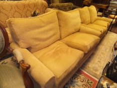 A pair of modern pale yellow upholstered two seat sofas