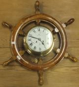 An oak cased mantel clock with Arabic numerals to the silvered dial on ogee bracket feet,