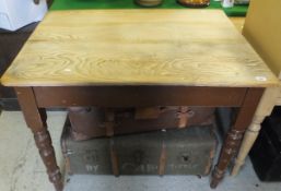 A pine topped kitchen table with brown painted turned and ringed legs