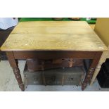 A pine topped kitchen table with brown painted turned and ringed legs