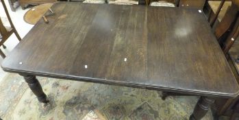 A Victorian dark oak stained extending dining table on turned and carved legs to brown china