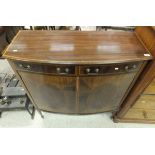 An Edwardian mahogany and satinwood banded bow fronted side cabinet with two drawers over two