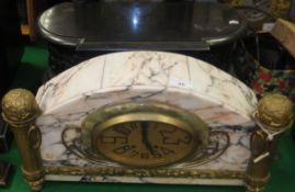 A 1930's French marble cased mantel clock, the oval brassed dial inscribed "Martin Nimes",