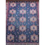 An Afghan tribal rug, the centre field with repeating star medallions in red,