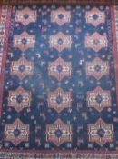 An Afghan tribal rug, the centre field with repeating star medallions in red,