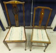 A set of four early 20th Century mahogany slat back dining chairs,