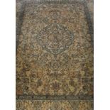 A Persian silk rug, the central medallion in cream, peach and blue,