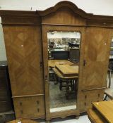 An early 20th Century Maple & Co Ld walnut veneered and inlaid breakfront wardrobe,