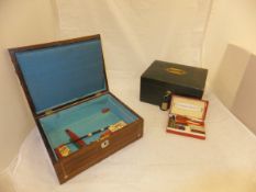 A rosewood and inlaid box containing various sealing wax, pens, etc,