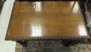 A carved oak single drawer side table,