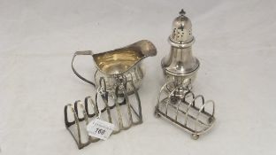 A silver sugar sifter, stamped to base "Sterling G83", a silver cream jug,