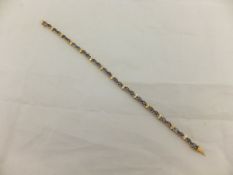 A yellow metal bracelet set with sapphires and small diamonds