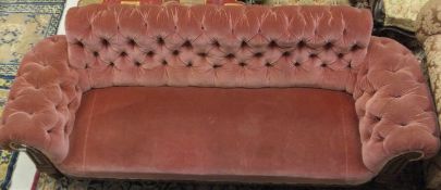 A Victorian button back scroll arm sofa with oak show frame to turned legs,