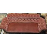 A Victorian button back scroll arm sofa with oak show frame to turned legs,