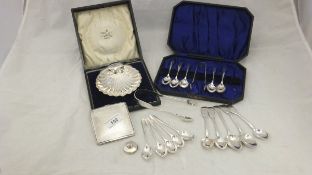 A set of six silver teaspoons and a pair of tongs,