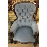 A Victorian button back upholstered tub chair, raised on turned and ringed legs,
