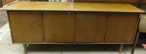 A 1950's teak four-door sideboard on square tapering legs