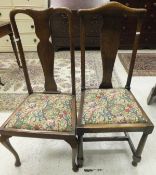 A set of four early 20th Century oak chairs with vase shaped back splats in the Queen Anne manner,