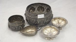 A collection of Eastern white metal wares to include an ornate pierced bowl with relief roundels