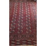 A Bokhara rug, the central elephant foot medallions in cinnamon, cream,