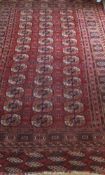 A Bokhara rug, the central elephant foot medallions in cinnamon, cream,