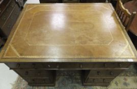 A Victorian oak partner's desk, the tooled and gilded leather insert top over three drawers,