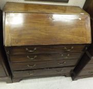 An early 19th Century mahogany bureau of four long drawers on bracket feet