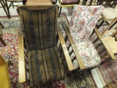 Two early to mid 20th Century oak framed elbow chairs with slatted sides and adjustable / reclining