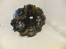 A Victorian black lacquered papier-mache mother of pearl inlaid and painted shaped panel decorated