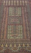 A Persian prayer rug, the central panel set with two pillars, both on a beige ground, within blue,