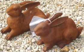 Two cast iron garden ornaments in the form of rabbits *