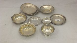 A box containing a collection of silver items to include a set of four small circular platters /