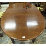 An oval mahogany extending dining table raised on turned and reeded legs to castors,