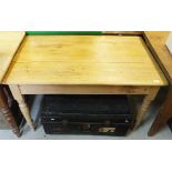 A Victorian pine topped kitchen table on turned and ringed legs,