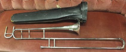 A silver plated trombone with foliate relief work decoration,