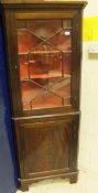 A reproduction mahogany corner cabinet