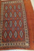 A Bokhara tribal saddle rug, the central repeating medallions in cinnamon,