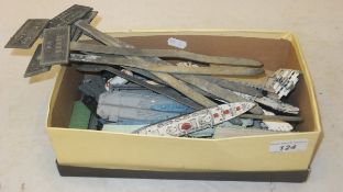 A shoe box containing a collection of vintage metal toys to include models of cruise liners,