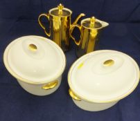 A pair or Royal Worcester lidded tureens with gilt highlighting on a white ground,