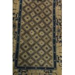 A Chinese throne rug, the central repeating stepped diamond shaped pattern in blue,