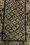 A Chinese throne rug, the central repeating stepped diamond shaped pattern in blue,