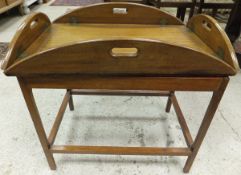 A drop sided mahogany butler's tray on stand