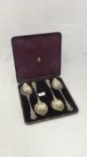 A set of four silver fruit spoons decorated with pharoahs masks and Egyptian ornament in the