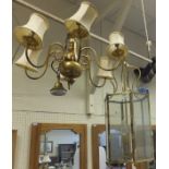 A modern hexagonal ceiling light with lacquered brass framework,
