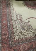 A Persian design carpet, the central medallion in pink,