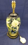 A Moorcroft Pottery table lamp decorated with white aquilegea on a graduated blue ground,