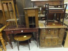 A Singer sewing machine in walnut case with assorted drawers and cupboards,